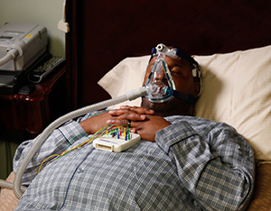 Man in bed undergoing sleep study.