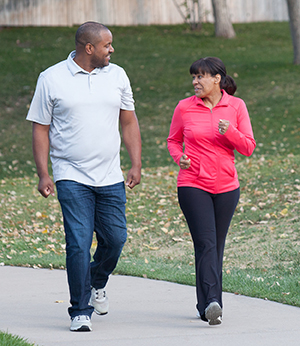 Man and woman walking in park.